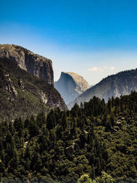 Scenic view of mountains against blue sky