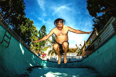 Low angle view of man against blue sky