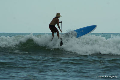 People surfing in sea