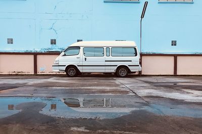 Car on street against building in city