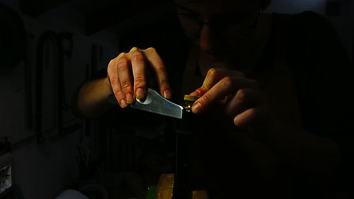 Midsection of man using mobile phone