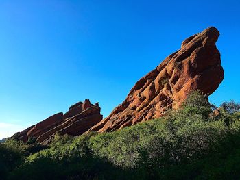 Low angle view of mountain against clear blue sky