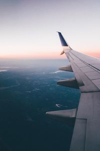 Cropped image of airplane flying over sea