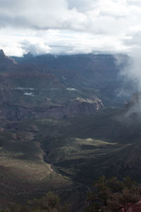 Scenic view of mountains against cloudy sky