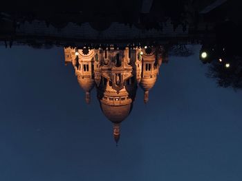 Church reflecting in puddle at night