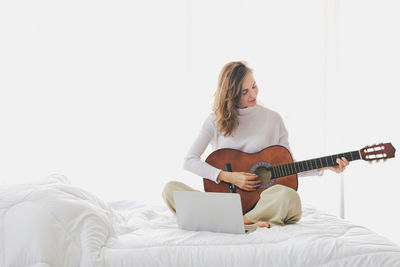 Full length of man playing guitar