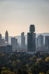 Buildings in city against sky during sunset