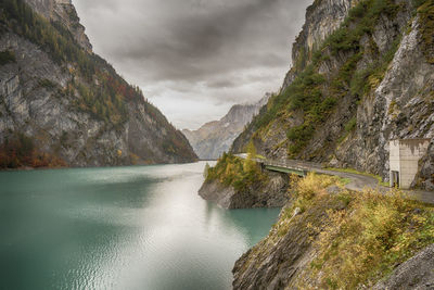 Scenic view of river amidst mountains against sky