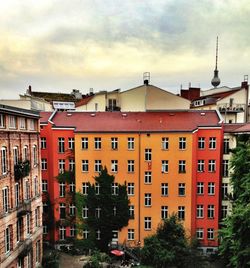 Buildings against cloudy sky