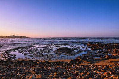 Scenic view of sea against clear sky during sunset