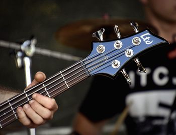 Cropped hand of man playing guitar
