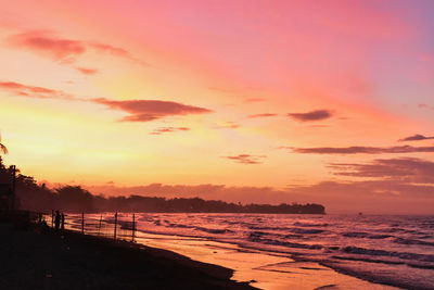 Scenic view of beach against sky during sunset