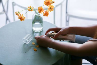 Midsection of woman holding bottle