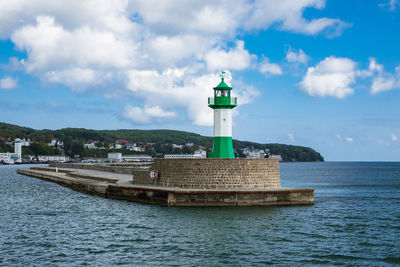 Lighthouse at sassnitz over baltic sea against sky