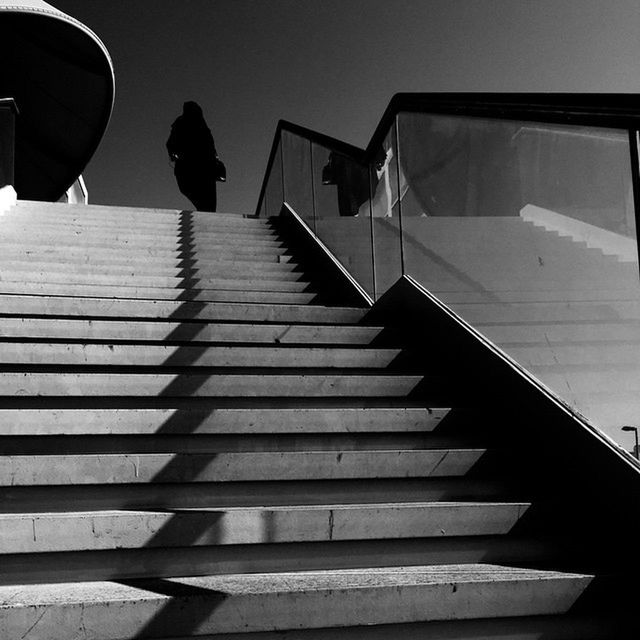 building exterior, built structure, architecture, low angle view, steps, steps and staircases, staircase, silhouette, building, railing, city, sky, shadow, sunlight, clear sky, day, outdoors, men