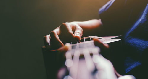 Close-up of man playing guitar