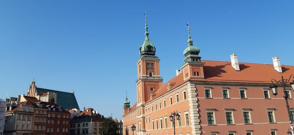 Low angle view of buildings against blue sky