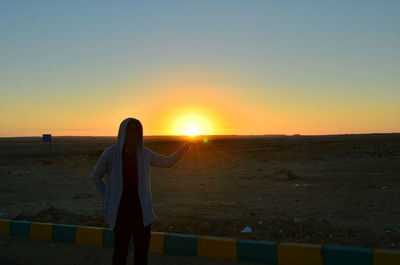 Rear view of man looking at sunset