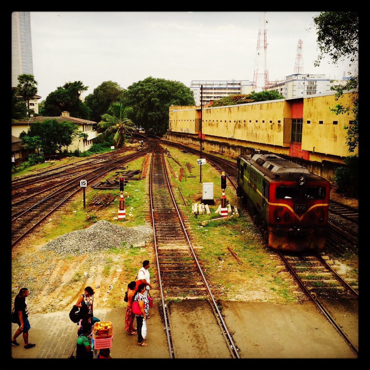 HIGH ANGLE VIEW OF PEOPLE STANDING AT RAILROAD STATION