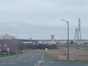 Road by city against sky