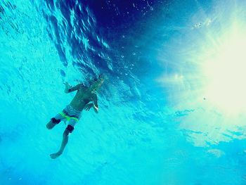 Low angle view of person swimming in pool