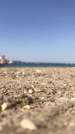 Surface level of beach against clear sky