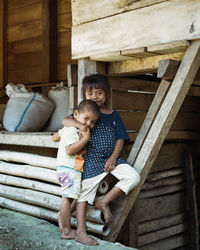 Rear view of mother and daughter on staircase