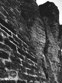 Low angle view of rock formation against sky