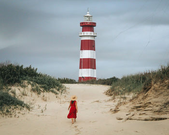 Rear view of woman standing on beach