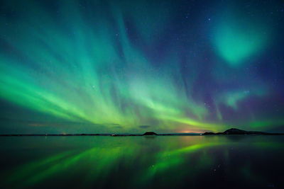 Scenic view of lake against sky at night