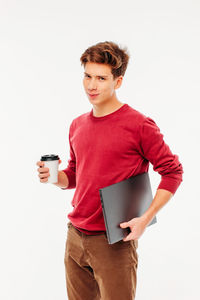 Young man drinking coffee cup against white background
