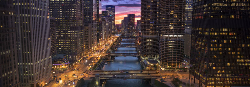 High angle view of illuminated buildings in city at night