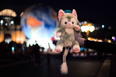 Close-up of stuffed toy hanging at night