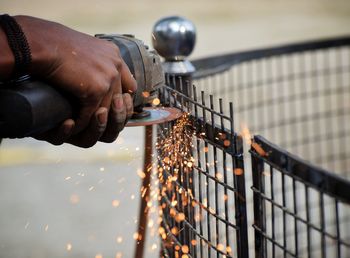 Midsection of man holding fire hydrant