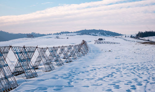 Scenic view of snow covered shore against sky