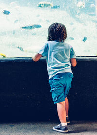 Rear view of boy at aquarium