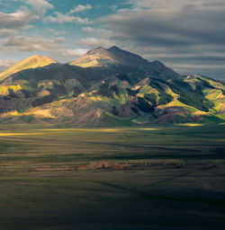 Scenic view of mountains against cloudy sky