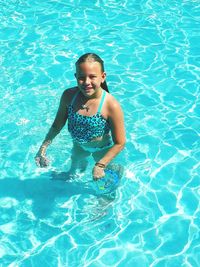 Full length of girl swimming in pool