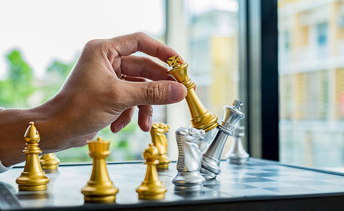 Midsection of person holding chess pieces
