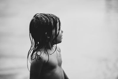 Shirtless girl standing at beach