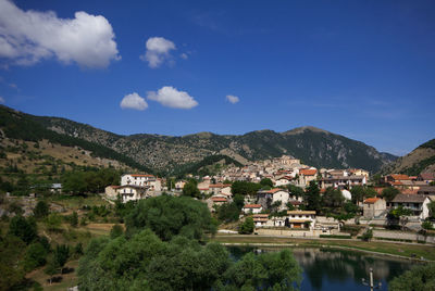 River amidst buildings in city against sky