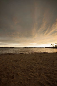 Scenic view of beach against sky during sunset