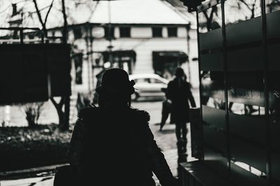 Rear view of women walking on building