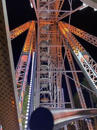 Low angle view of illuminated ferris wheel at night