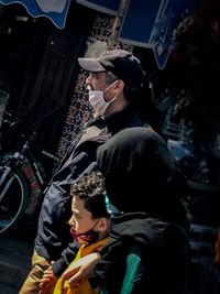 Side view of people looking at market