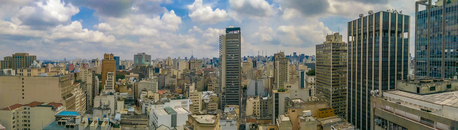 Panoramic view of modern buildings against sky in city
