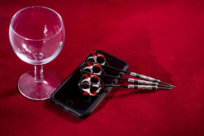 Close-up of drink on table against red background