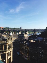 High angle view of buildings by river against sky