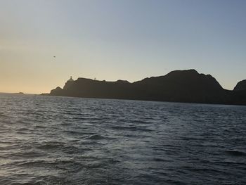 Scenic view of sea against clear sky during sunset
