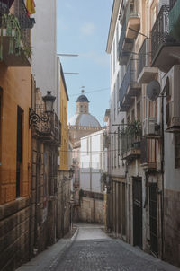 Narrow street amidst buildings in town